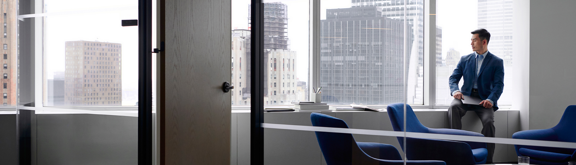 Employee looking out of office window