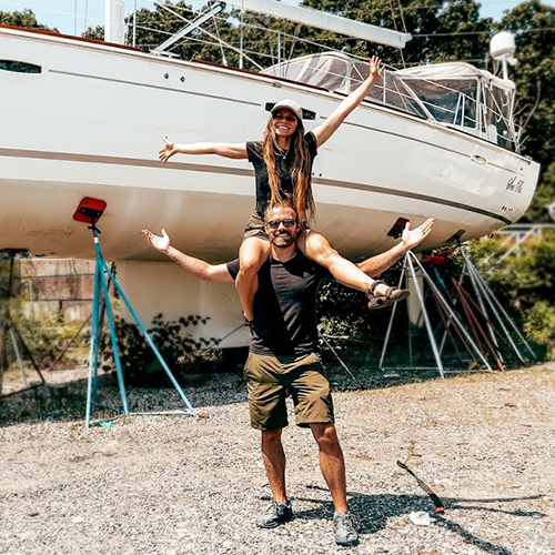 Brett and Jade Evans in front of their boat